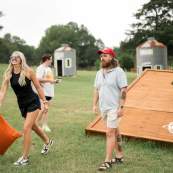 A couple plays cornhole on the giant boards at Helena Hollow.