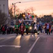 people walking in the christmas parade for lighting up downtown