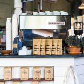 A close-up of the counter and espresso machine at Congregation Coffee - Algiers Point