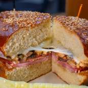 a Muffuletta sandwich on a table with a pickle