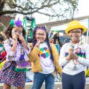 Kids Waiting for A Mardi Gras Parade to Roll