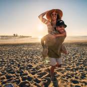 Couple Piggyback on Beach in Oceanside