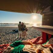 Couple in Oceanside looking at the water view from the VW bus