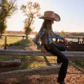 Taylor Thoman climbing fence