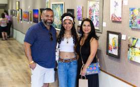 Photos of a family after checking in to Spring Art Stomp at the Brownwood Art Center featuring the gallary of art behind them on the walls.