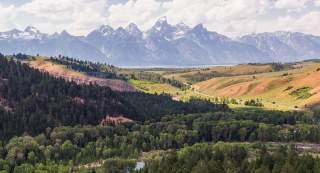 Scenic view of Grand Teton National Park with towering peaks and lush forests in Sublette County, Wyoming.