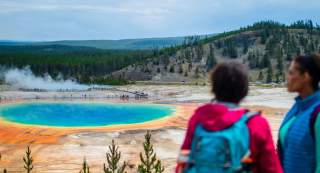Expansive view of visitors viewing the Grand Prismatic spring in Yellowstone National Park.