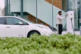 Man testing electric car charging point at EBRI Research Facilities, Aston University