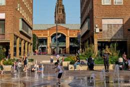 Families playing in a water fountain in Coventry city centre