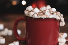 a red mug of hot chocolate with marshmallows on top