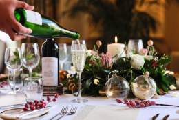 christmas dinner table and a glass of bubbly being poured