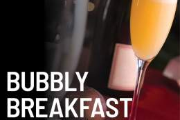 a glass with orange and bubbly and writing bubbly breakfast