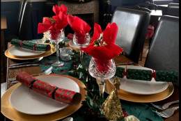 table set for christmas with decorations and crackers