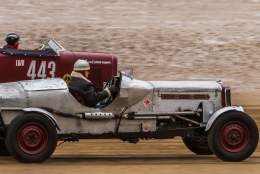 Two vintage car roaring across Bridlington's south beach as part of the Race the Waves event in East Yorkshire