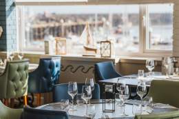 The dining area at Salt on the Harbour with Bridlington harbour visible in the background through the window.