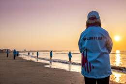 HEY volunteers standing on Bridlington beach on the shoreline