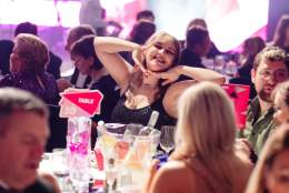 A guest posing at the table at the 2023 REYTAs