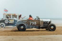 2 vehicles racing along the beach
