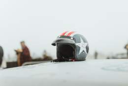a close up of a helmet on a car bonnet