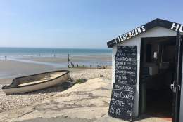 a view of east wittering beach with seafood hut