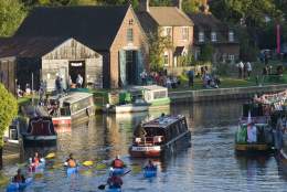 People take part in a pageant on the River Wey and Godalming Navigations, image credit National Trust