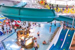 Swimming pool with slides and families at Guildford Spectrum