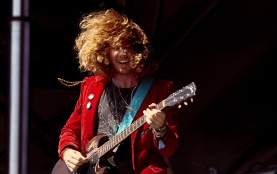 Ben Kweller playing guitar at ACL Fest in red blazer with buttons