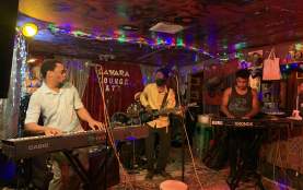 Three members of Crucial Prophet reggae band on stage at the Sahara Lounge