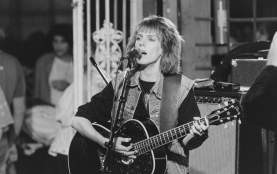 Black and white photo of Lucinda Williams performing with guitar at Black Cat Lounge