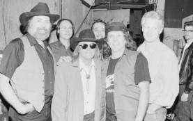 Black and white photo of members of the Texas Tornados smile at camera