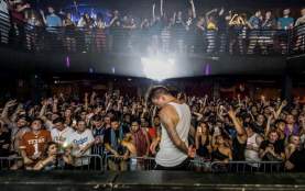 Artist on stage at Vulcan Gas Company in front of crowd on two levels