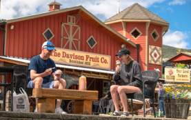 Visitors enjoying real fruit ice cream outside at Davison Orchards Country Village near Kelowna