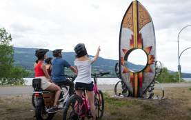 Family Viewing Indigenous syilx Artwork along Okanagan Rail Trail