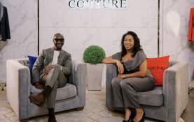 Two people sitting in plush chairs at fashion store