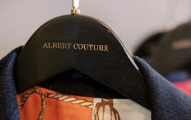 Close up of hanger with the name ALBERT COUTURE
