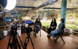 Behind the scenes of a video shoot with three women during interview