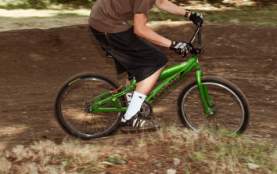 A person turning the corner mountain biking.