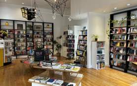 Bookstore layout with books on tables, shelves, and displays.