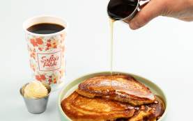 Pouring syrup over buttermilk pancakes at Safta's Table