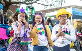 Kids Waiting for A Mardi Gras Parade to Roll