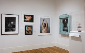 An art gallery with framed pictures on the wall.