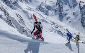 NZ Mountain Film & Festival 2025 hero image of three adventurers boot packing up a snowy ridgeline