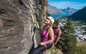 Two people rock climbing above Queenstown with Via Ferrata