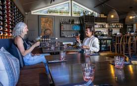 Two people enjoying a drop of wine at Fino Restaurant & Wine Bar at the Queenstown Marina in Frankton