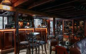 The inside of an old pub with wooden and leather furnishings