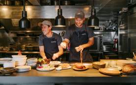 Staff dishing up plates at Muttonbird Restaurant in Wānaka
