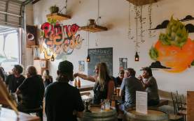 Friends enjoying craft beer at Rhyme x Reason in Wānaka's industrial area