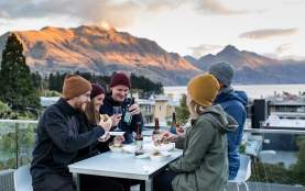 Friends enjoying cold beverages o the balcony at mi-pad