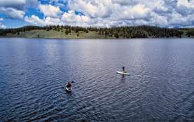 two paddle boarders on a lake