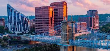 The skyscrapers, The Ascent and Rivercenter Towers behind the Roebling Bridge and Ohio river on a sunny day